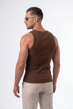 [Chocolate] Man wearing a brown tank top and light-colored pants on a white background