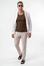 [Chocolate] Man wearing a brown shirt, beige pants, and a light jacket on a white background