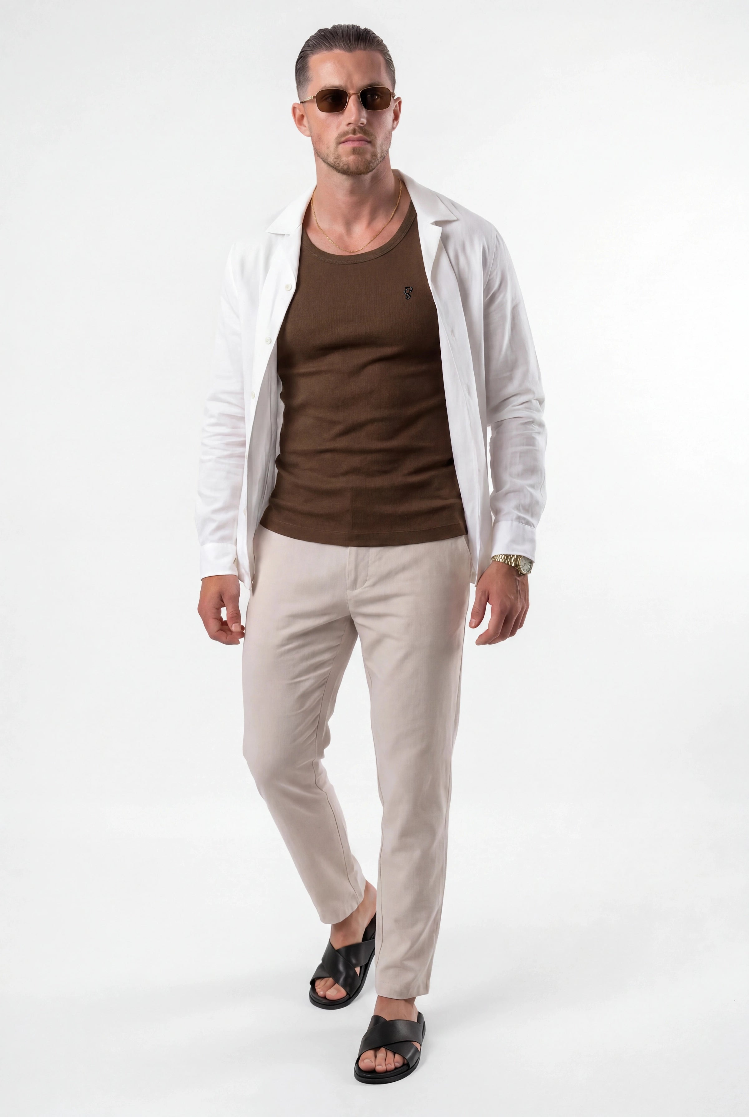 [Chocolate] Man wearing a brown shirt, beige pants, and a light jacket on a white background