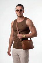 [Chocolate] Man wearing a brown tank top and sunglasses, holding a brown leather bag on a white background
