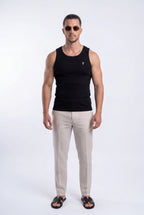 [Black] Man wearing a black tank top and beige pants on a white background