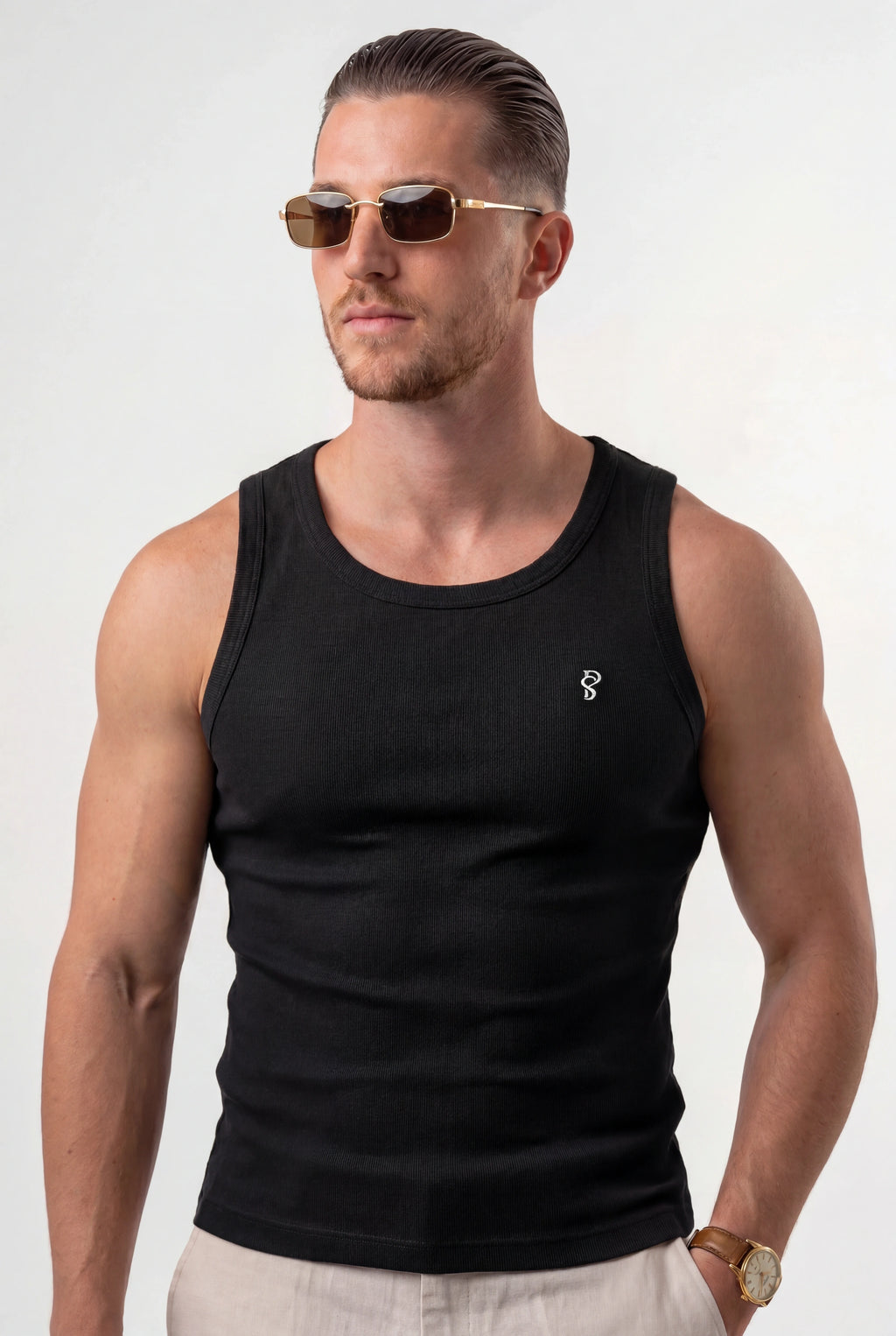 [Black] Man wearing a black tank top with a small logo on a white background