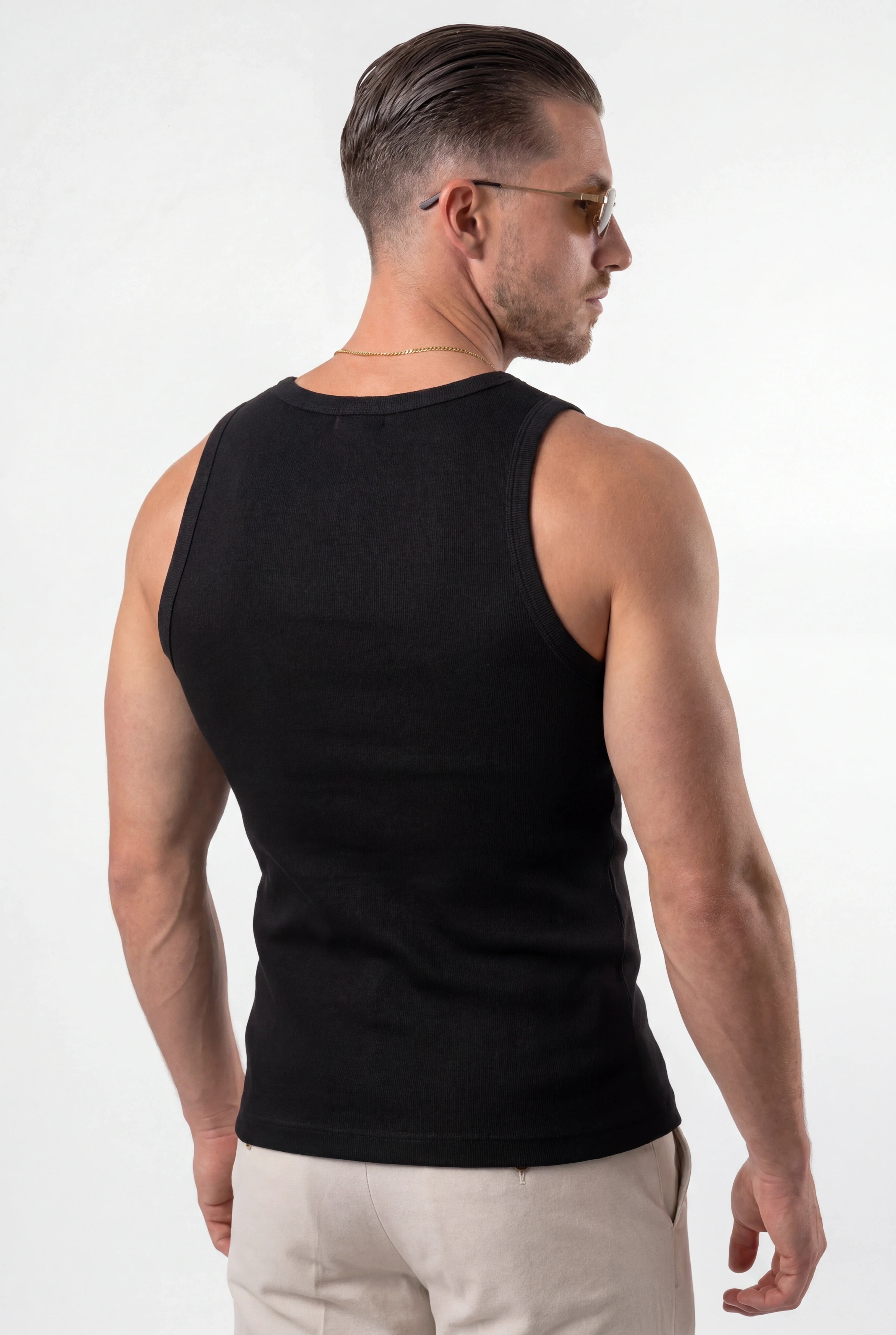[Black] Man wearing a black tank top on a white background